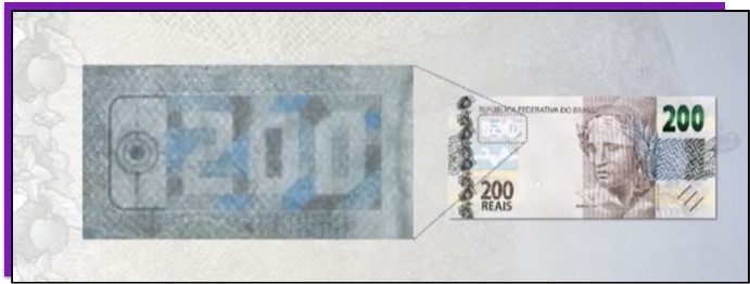Detalhe da nota de 200 reais que mostra o número 200 dentro de um quebra-cabeça