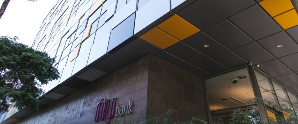 Compromisso Nubank contratar 2 mil negros: imagem da fachada do prédio do Nubank com o logo roxo e vidros amarelos, cinzas e pretos