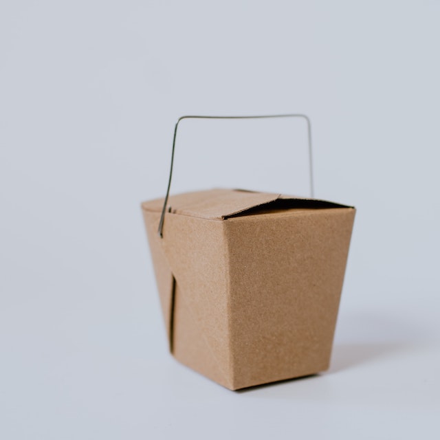 Pandemia faz número de MEIs aumentar: fotografia de uma caixinha de comida de papel pardo num fundo branco
