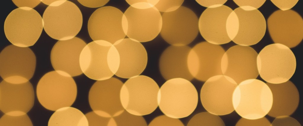 imagens de pontos dourados com fundo preto semelhantes a pixels. Foto: @graphem/ Unsplash