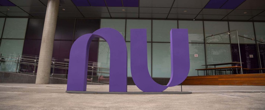 Imagem da fachada do prédio do Nubank em São Paulo, com o logo NU roxo em evidência